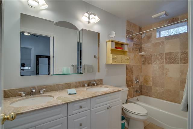 4215 Sneed Road Nashville, TN 37215 - Photo 13 of 20 a bathroom with a granite countertop sink toilet and shower