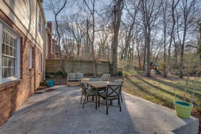 4215 Sneed Road Nashville, TN 37215 - Photo 19 of 20 a view of a patio with table and chairs with wooden floor and fence