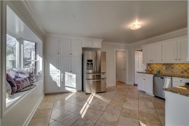 4215 Sneed Road Nashville, TN 37215 - Photo 6 of 20 a kitchen with a refrigerator and a stove top oven