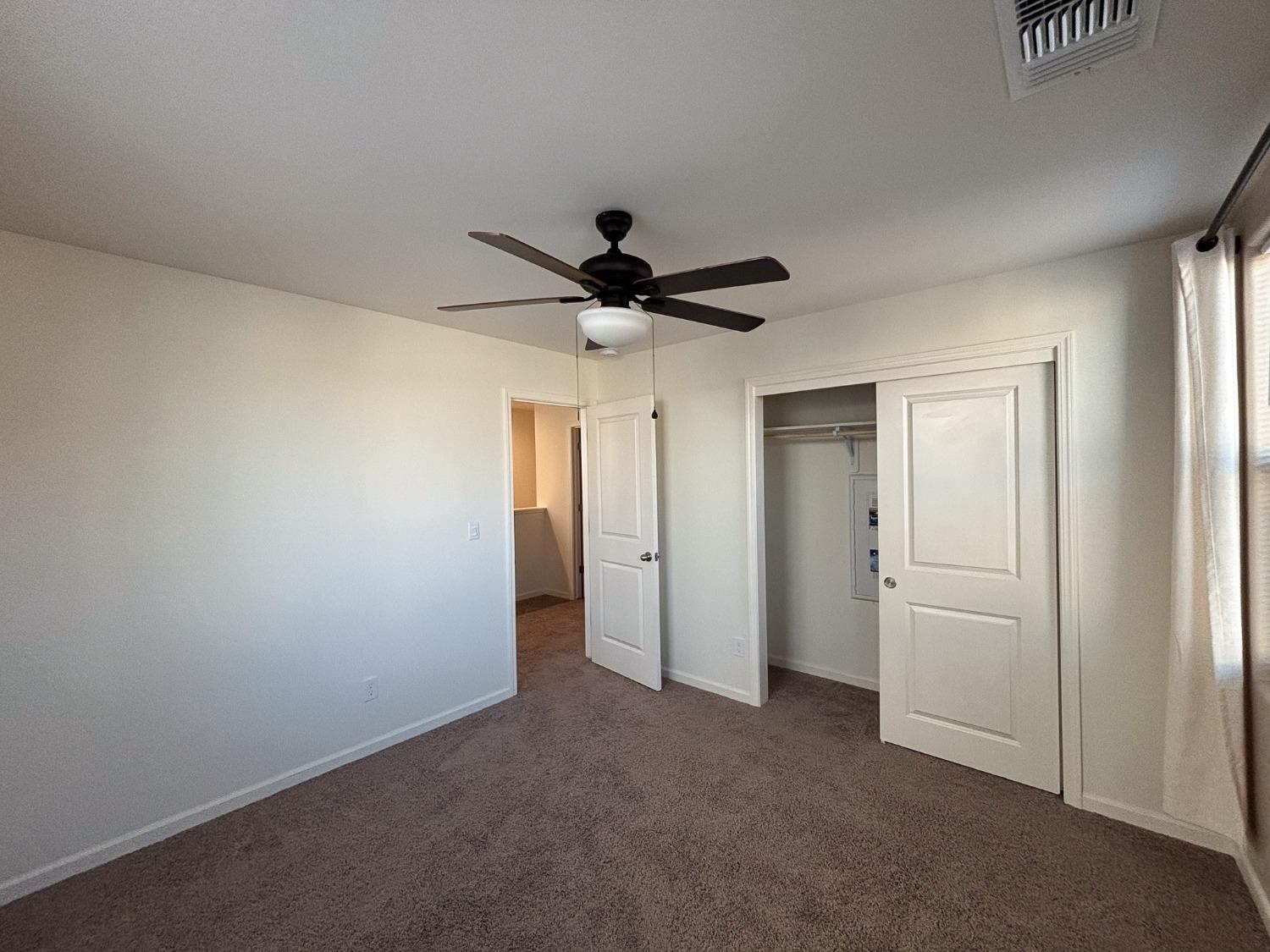 827 Fir Street West Madera, CA 93636 - Photo 26 of 63 a very nice looking room with a ceiling fan