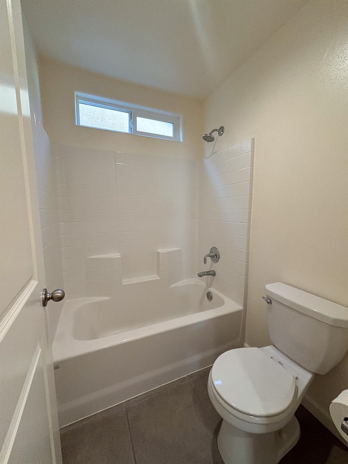 827 Fir Street West Madera, CA 93636 - Photo 33 of 63 a white toilet and tub sitting next to a bathroom sink