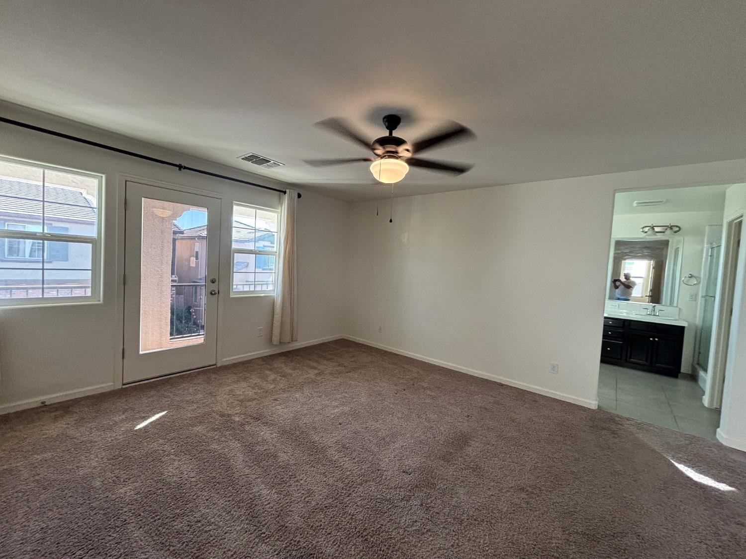 827 Fir Street West Madera, CA 93636 - Photo 38 of 63 an empty room with chandelier fan and windows