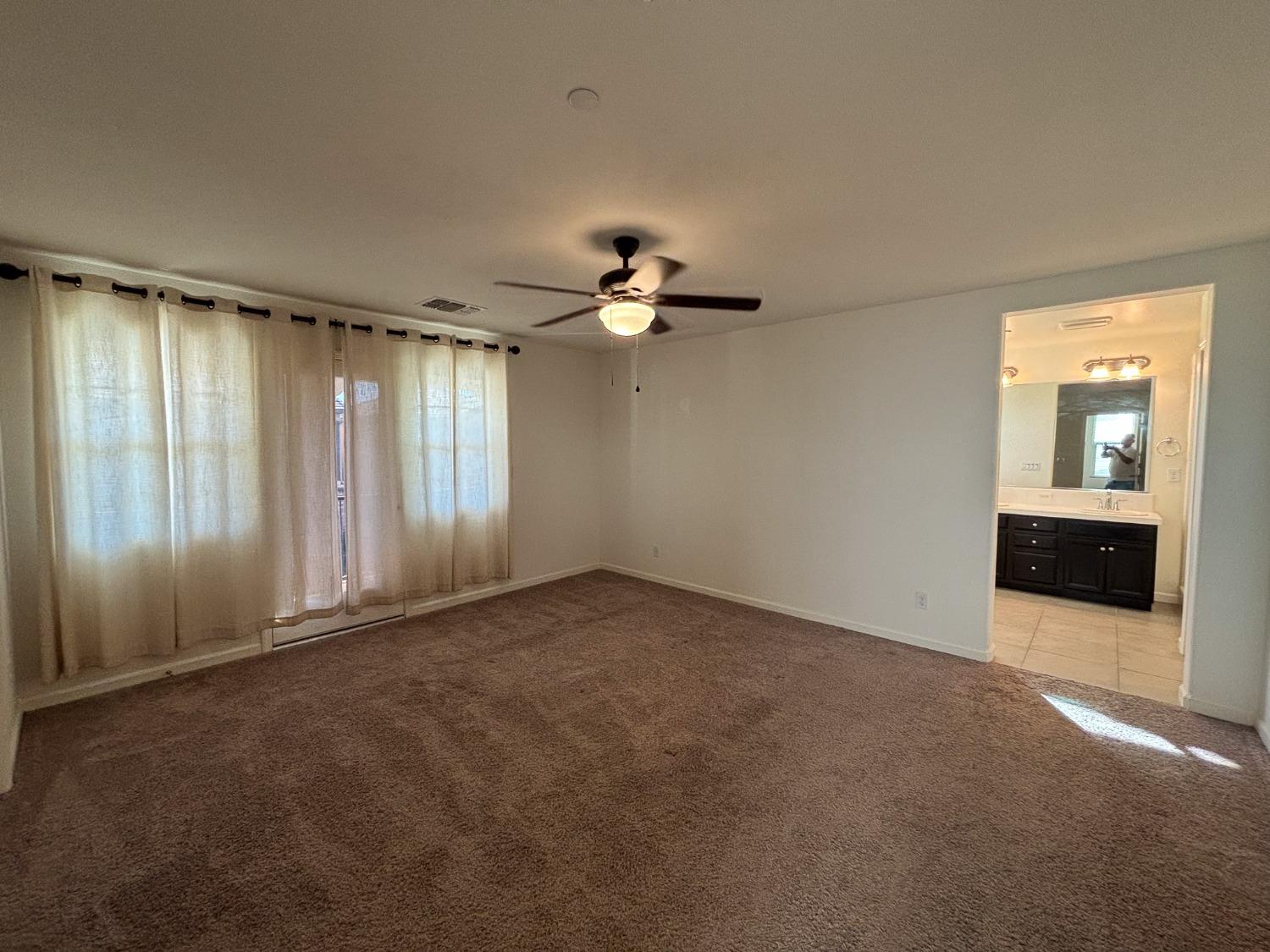 827 Fir Street West Madera, CA 93636 - Photo 44 of 63 a view of a livingroom with a ceiling fan and window