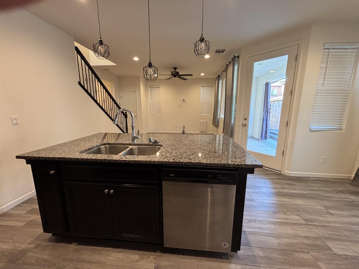 827 Fir Street West Madera, CA 93636 - Photo 6 of 63 a view of a kitchen with a sink and wooden floor