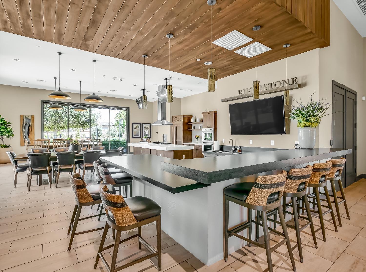 827 Fir Street West Madera, CA 93636 - Photo 62 of 63 a dining hall with stainless steel appliances kitchen island granite countertop a table and chairs