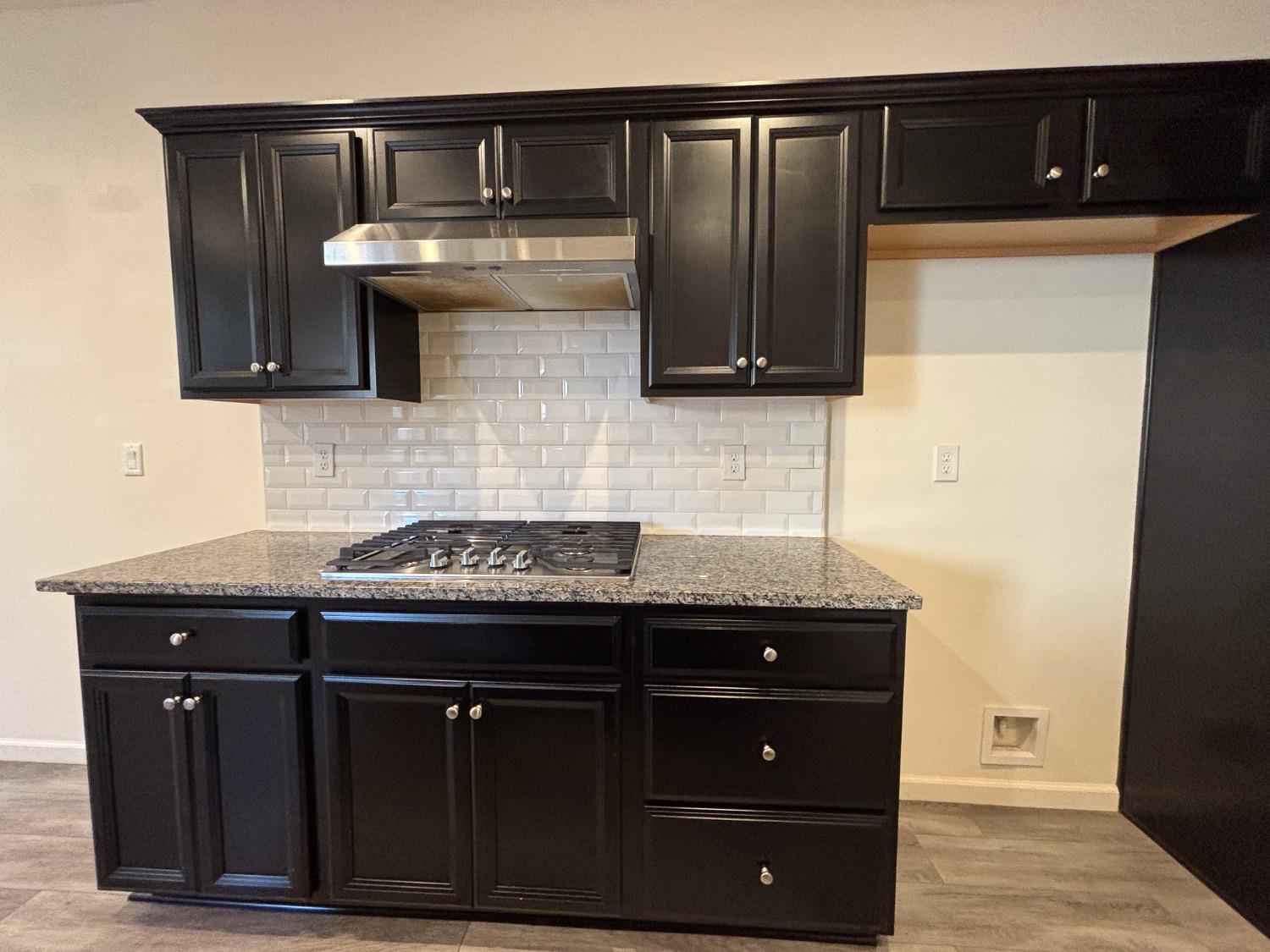 827 Fir Street West Madera, CA 93636 - Photo 7 of 63 a kitchen with granite countertop stainless steel appliances wooden cabinets and a sink