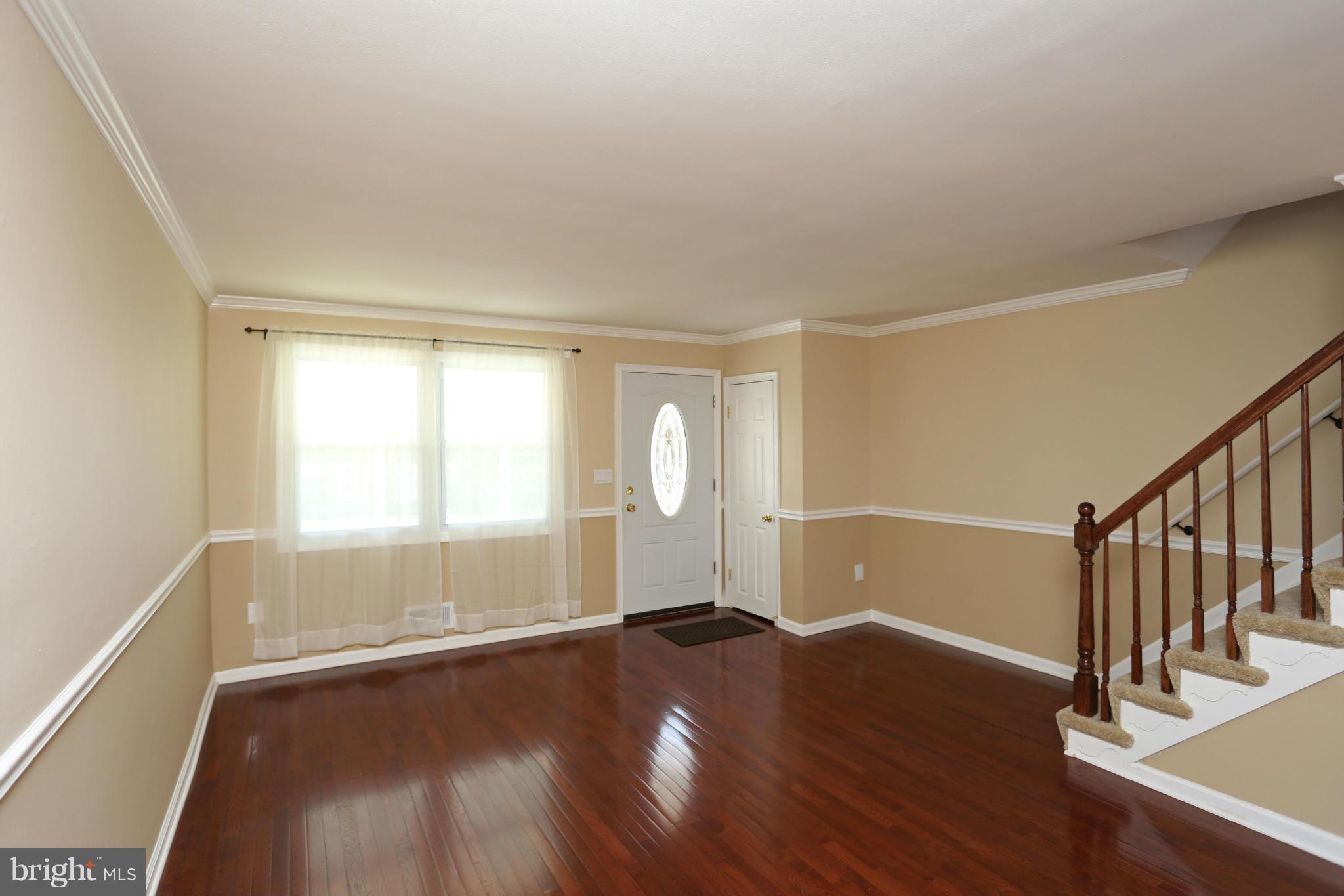 4440 Fenor Road Baltimore, MD 21227 - Photo 5 of 30 wooden floor in an empty room with a window