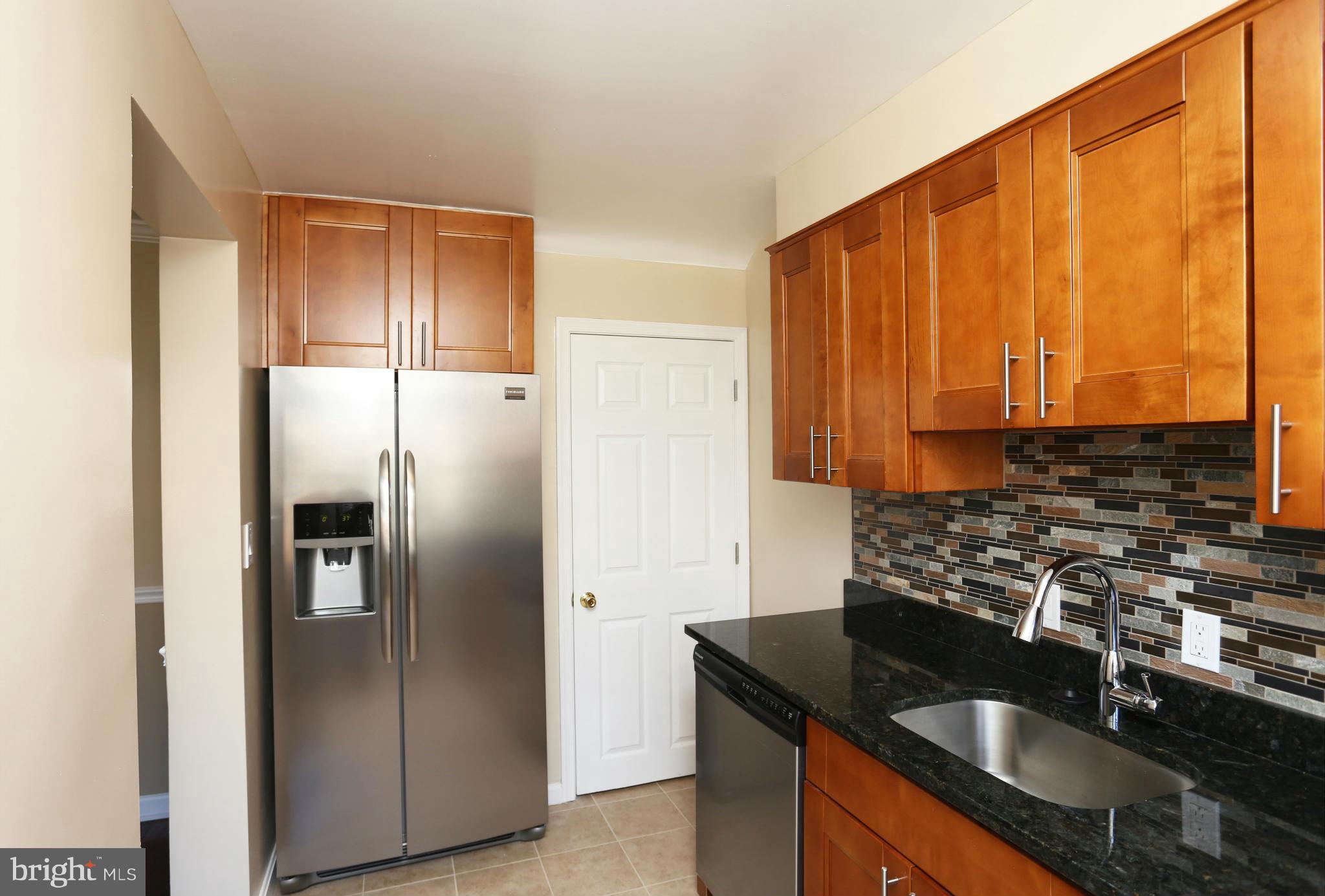 4440 Fenor Road Baltimore, MD 21227 - Photo 10 of 30 a kitchen with stainless steel appliances granite countertop a refrigerator a sink and a stove