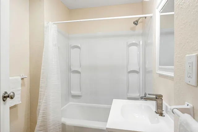 a bathroom with a tub and a sink