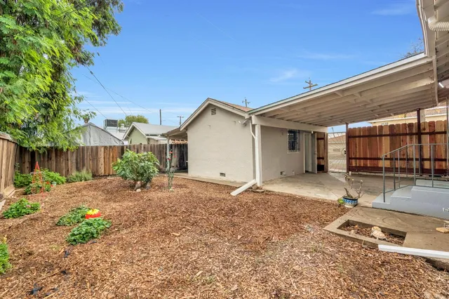 a backyard of a house with yard and outdoor seating