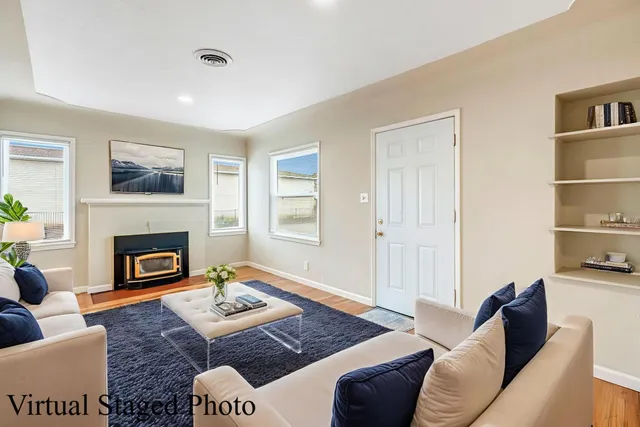 a living room with furniture a rug and a fireplace