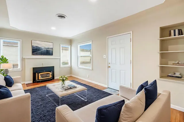a living room with furniture fireplace and window