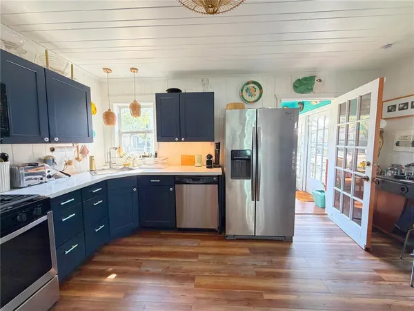 a kitchen with stainless steel appliances granite countertop a refrigerator and a sink