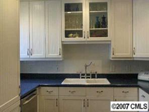 440 Westbury Road Charlotte, NC 28211 - Photo 5 of 8 a kitchen with a sink and cabinets