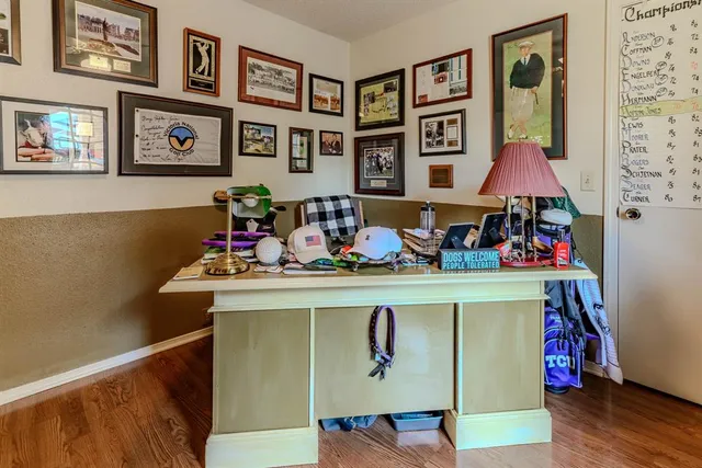 a table with chairs and painting on the wall