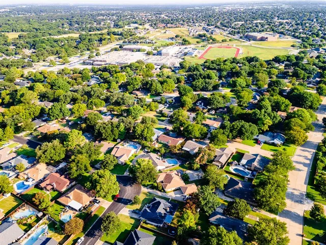 an aerial view of residential house with swimming pool and outdoor space