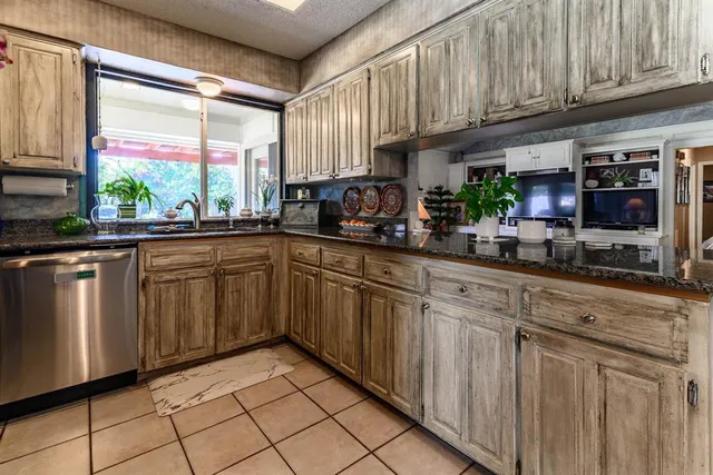 a kitchen with a sink cabinets and window