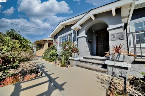 a view of kitchen with windows and refrigerator