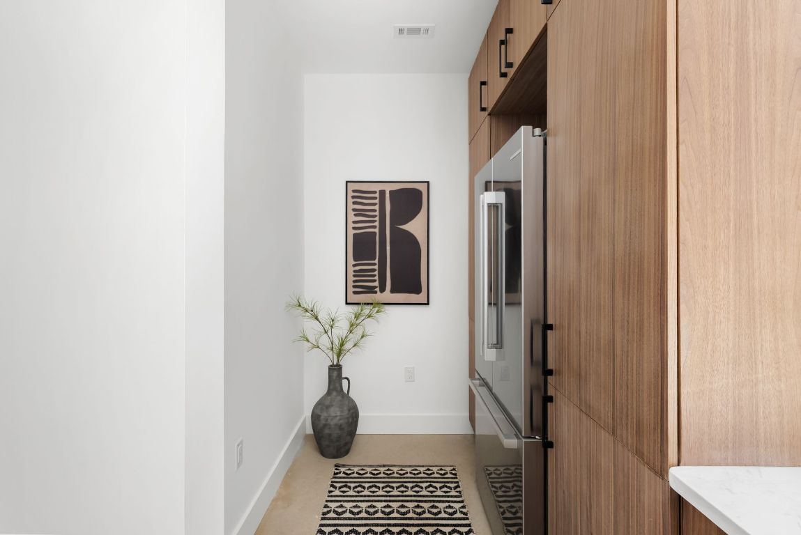 5212 Evans Avenue Austin, TX 78751 - Photo 12 of 34 a view of a hallway with a potted plant and wooden floor