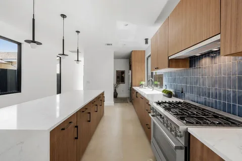 a kitchen with sink stove and cabinets