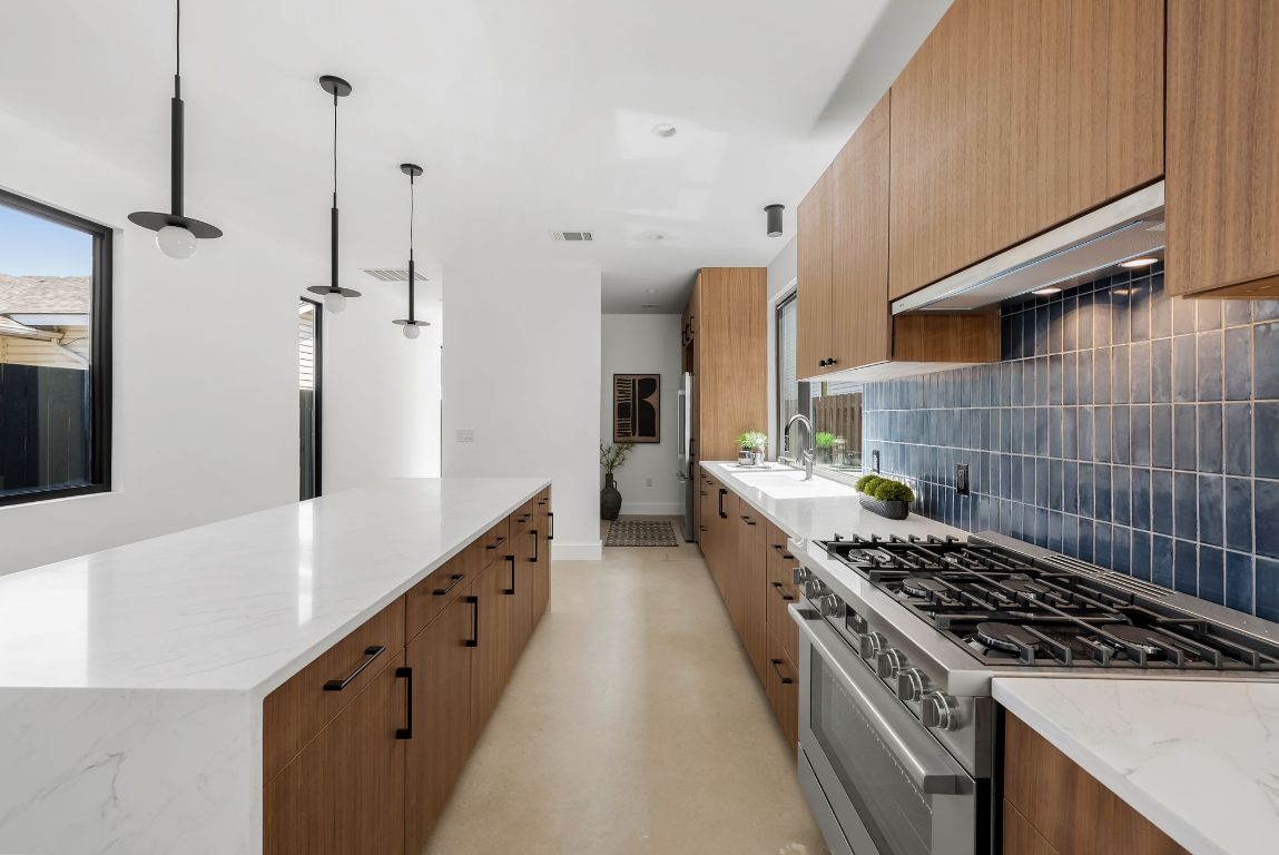 5212 Evans Avenue Austin, TX 78751 - Photo 13 of 34 a kitchen with sink stove and cabinets