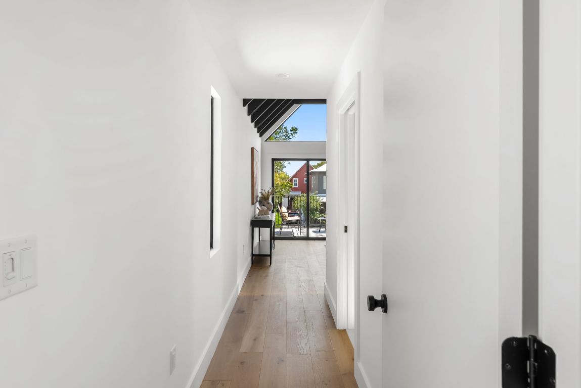 5212 Evans Avenue Austin, TX 78751 - Photo 16 of 34 a view of a hallway with wooden floor and a living room