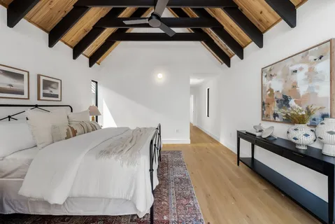 a living room with a bed and furniture