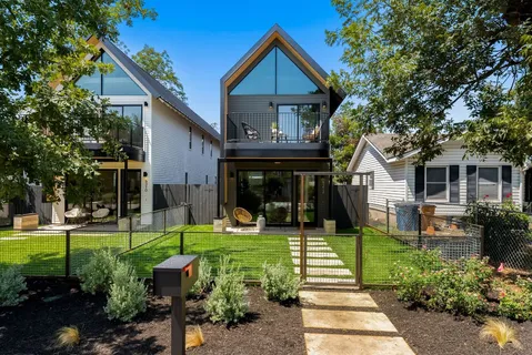 a front view of a house with a yard table and chairs