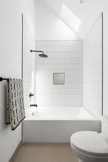 a bathroom with a bathtub and shower
