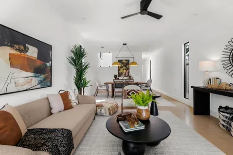 a living room with furniture and a wooden floor