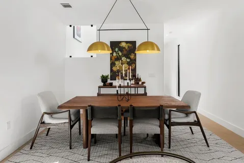 a view of a dining room with furniture and chandelier