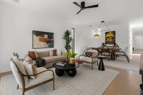 a living room with furniture and wooden floor