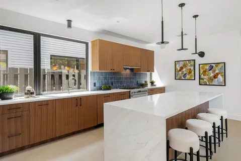 a large kitchen with lots of counter space and windows
