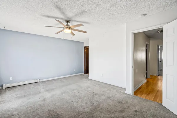 a bedroom with a bed and a potted plant