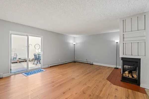 a view of an empty room with a fireplace and a fireplace