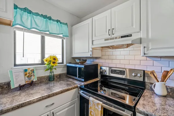 a view of a kitchen with a sink and cabinets