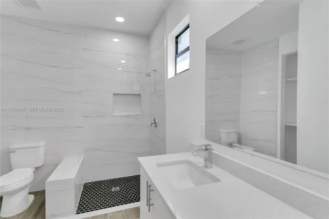 a view of kitchen with stainless steel appliances kitchen island wooden floor and window