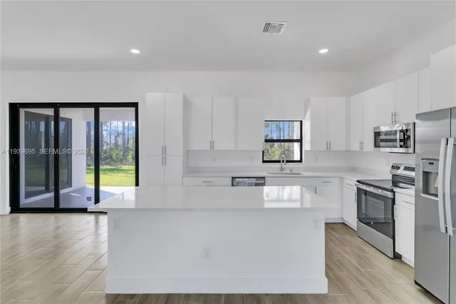 a view of a kitchen with microwave and cabinets