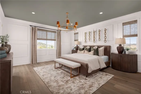 a spacious bedroom with a bed a couch and a window