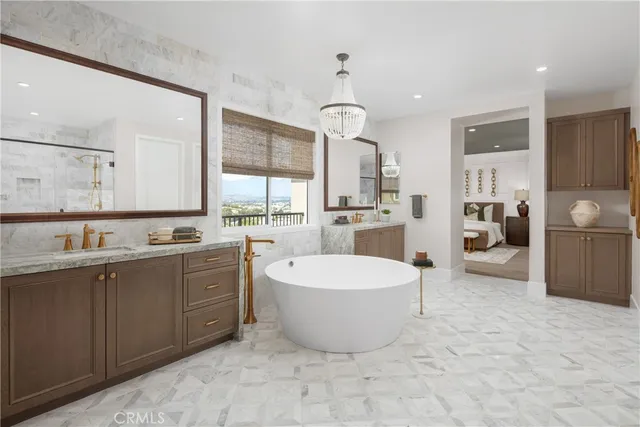 a large room with kitchen island a sink a counter space and stainless steel appliances