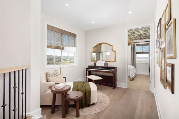a living room with furniture a piano and a window