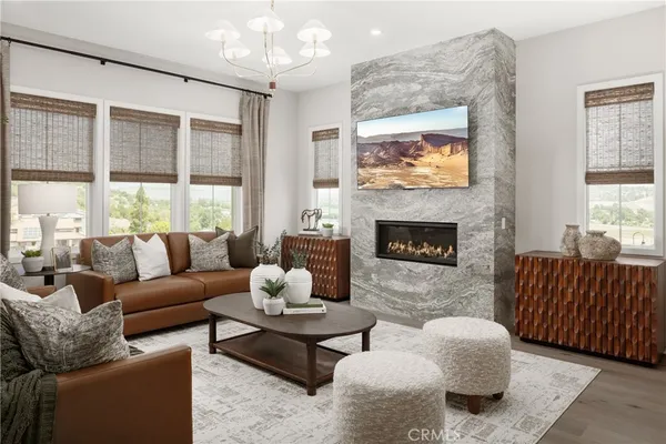 a living room with furniture large window and a fireplace