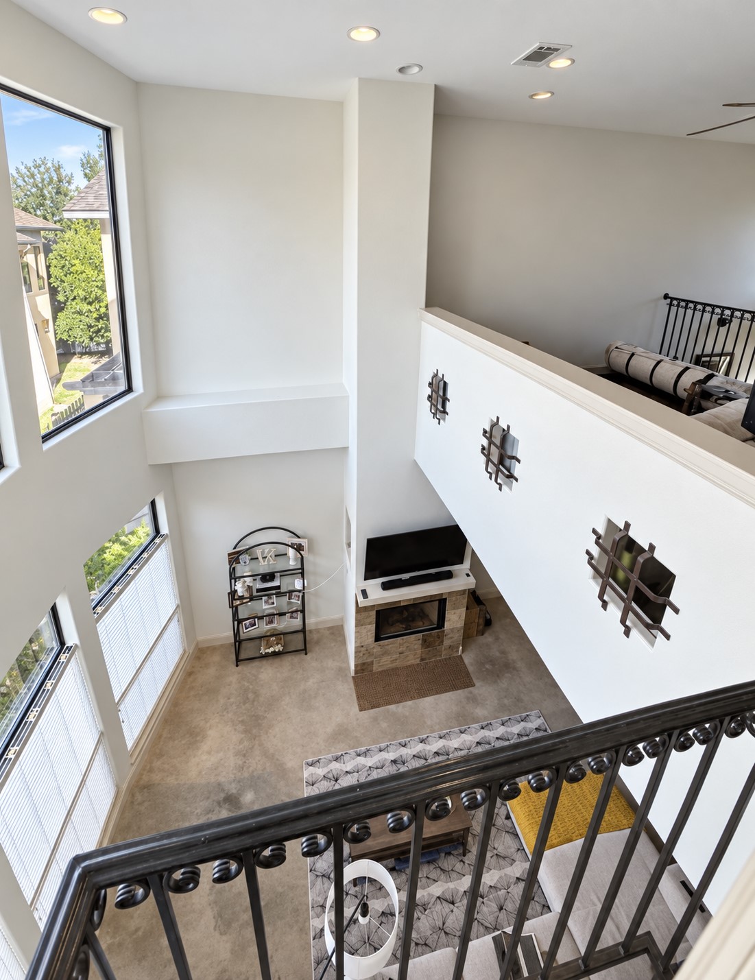 2316 Thornton Road, Unit B Austin, TX 78704 - Photo 13 of 25 Double-height windows and a stone fireplace anchor this soaring, open-concept living space.