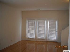 2726 Avalon Loop Road, Unit 2726 Charlotte, NC 28269 - Photo 4 of 10 an empty room with wooden floor and windows