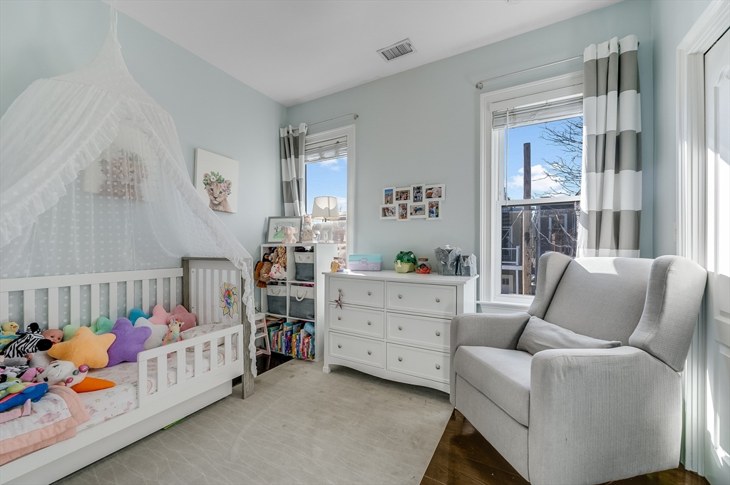 720 East 8th Street, Unit 2 Boston, MA 02127 - Photo 11 of 14 a bedroom with furniture and a window