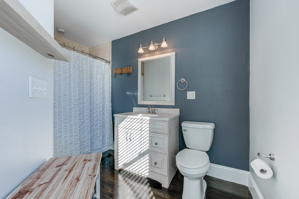 720 East 8th Street, Unit 2 Boston, MA 02127 - Photo 8 of 14 a bathroom with a toilet sink and mirror