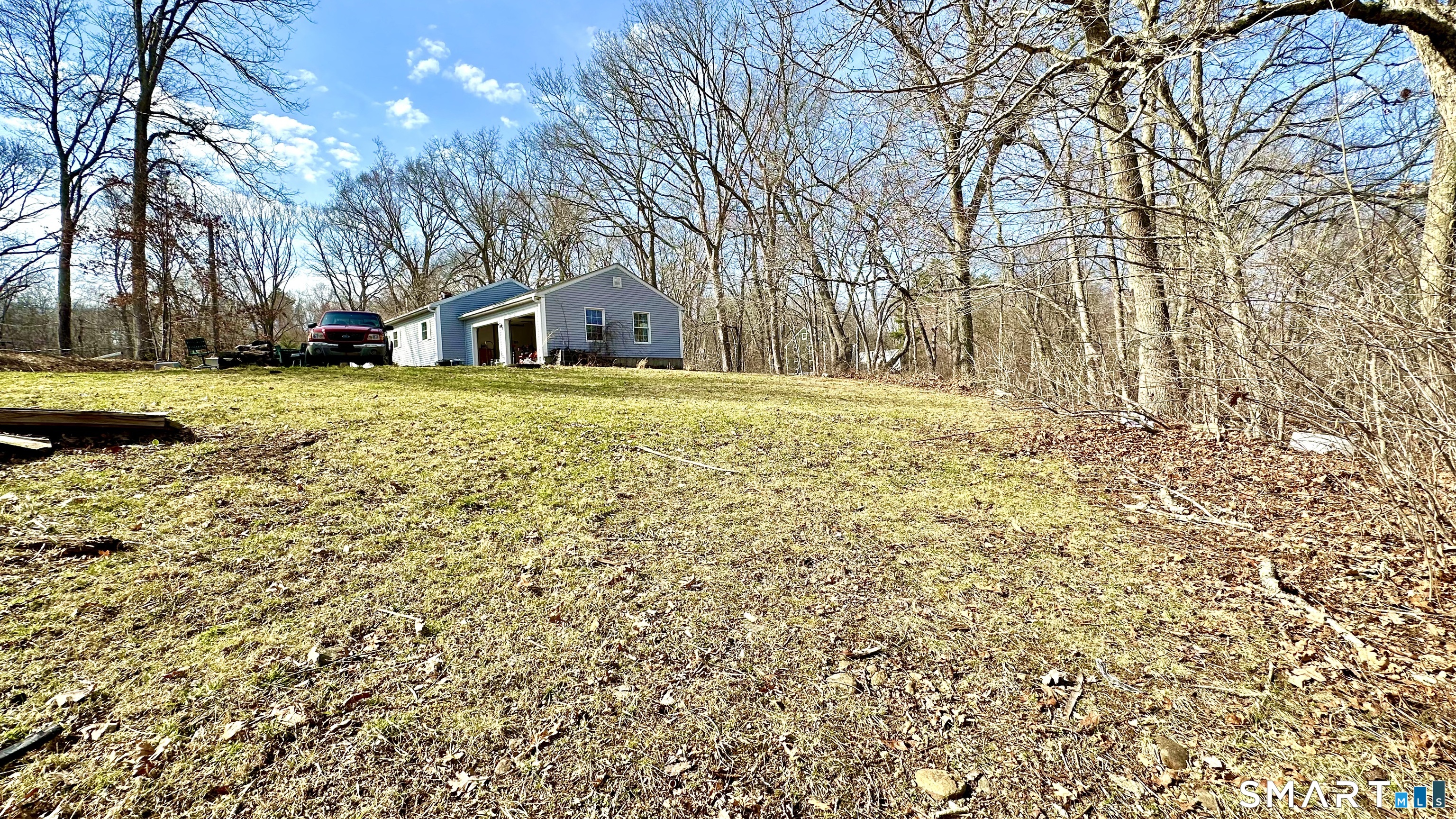 512 Brook Road Scotland, CT 06247 - Photo 18 of 22 a yellow house with trees in front of it