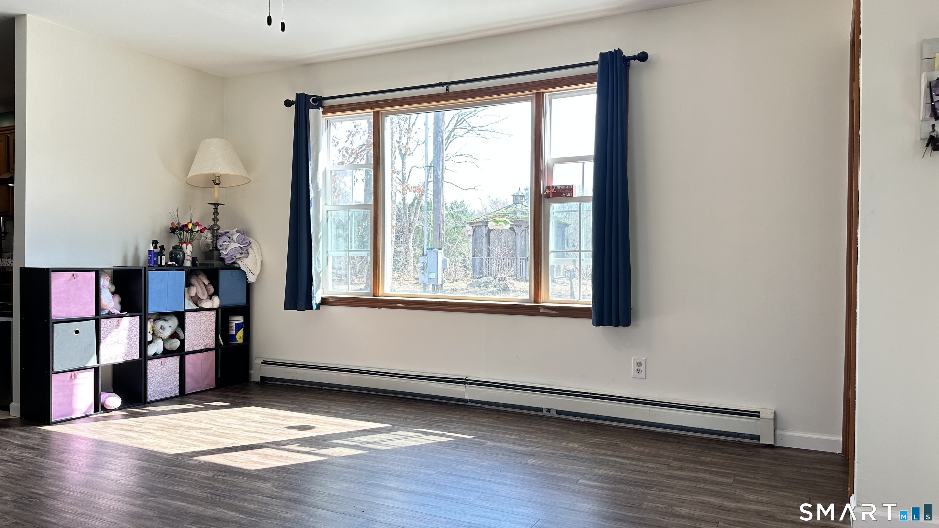 512 Brook Road Scotland, CT 06247 - Photo 2 of 22 a view of an empty room with window and wooden floor