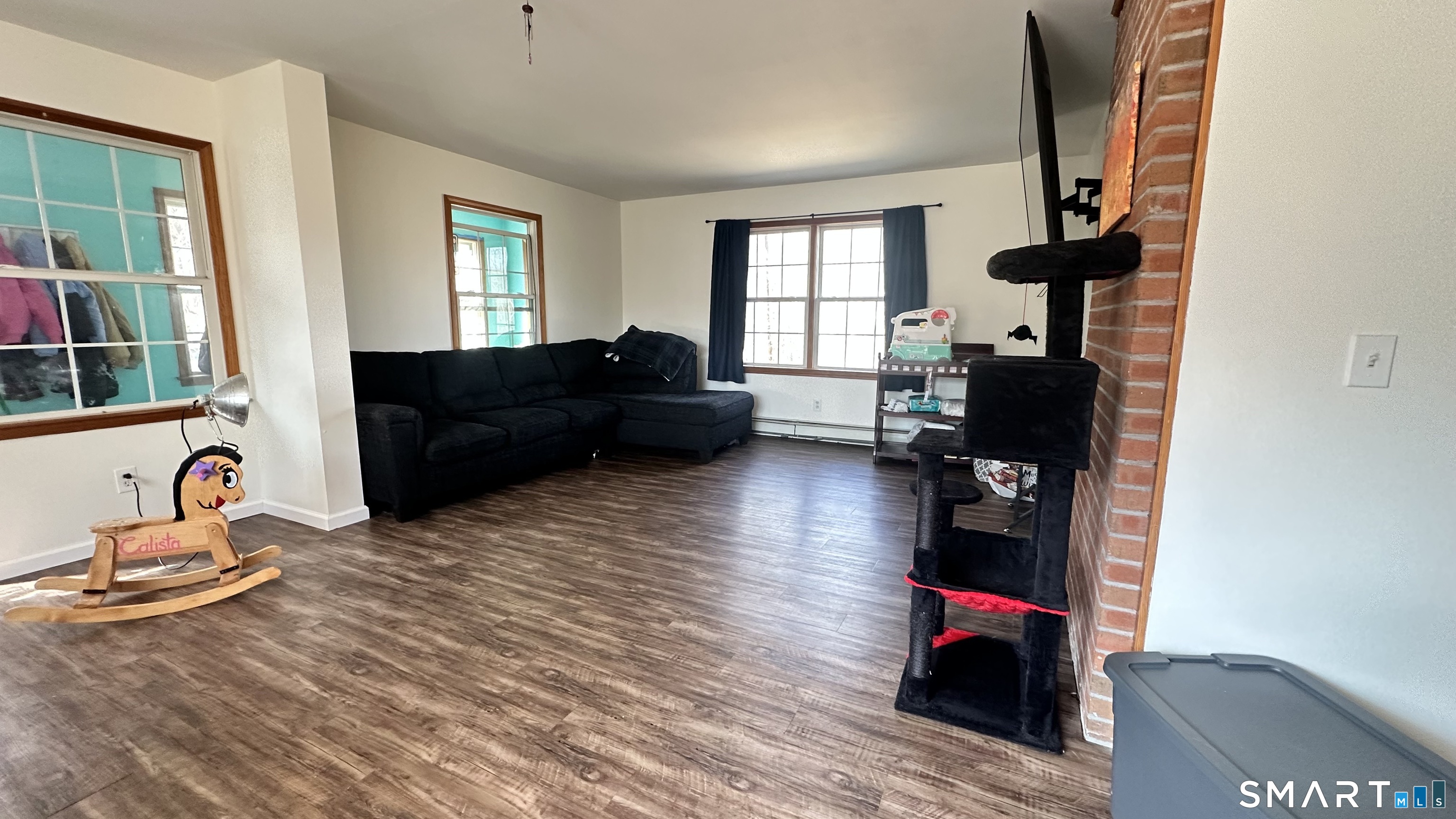 512 Brook Road Scotland, CT 06247 - Photo 4 of 22 a living room with furniture windows and a wooden floor