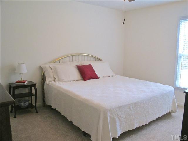 6509 Dew Drop Court Raleigh, NC 27613 - Photo 17 of 25 a bedroom with a bed and a lamp